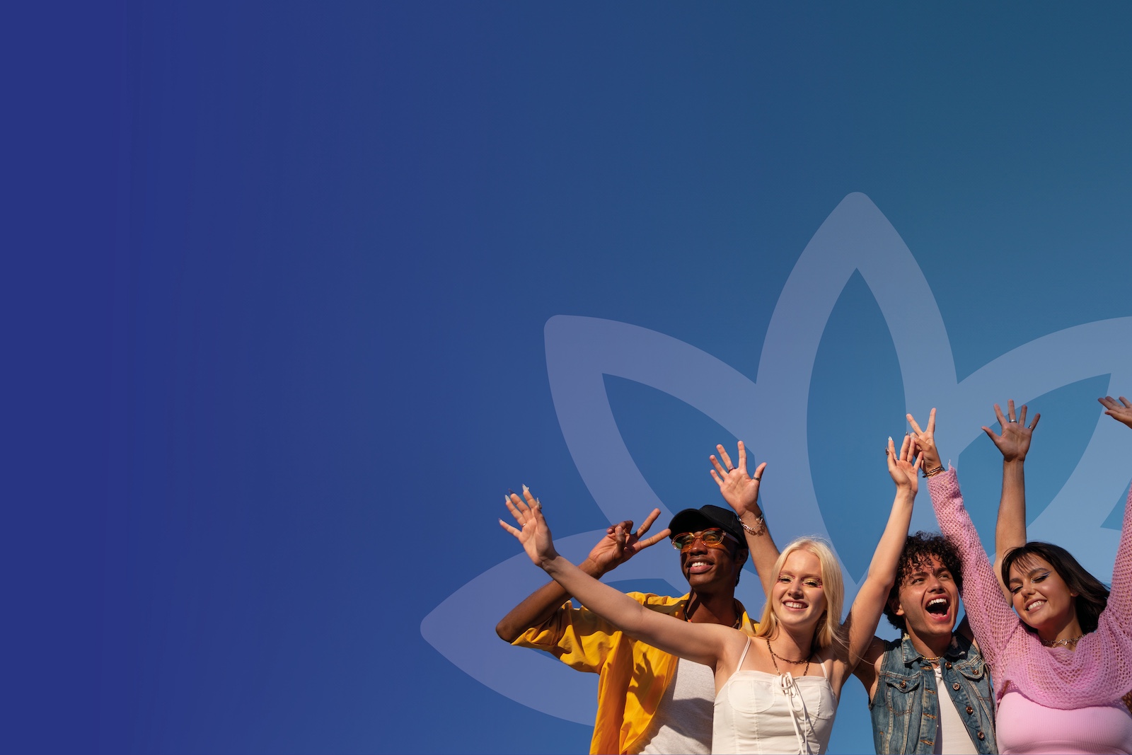 A diverse group of young adults in colourful clothing waiving their arms towards the sky.